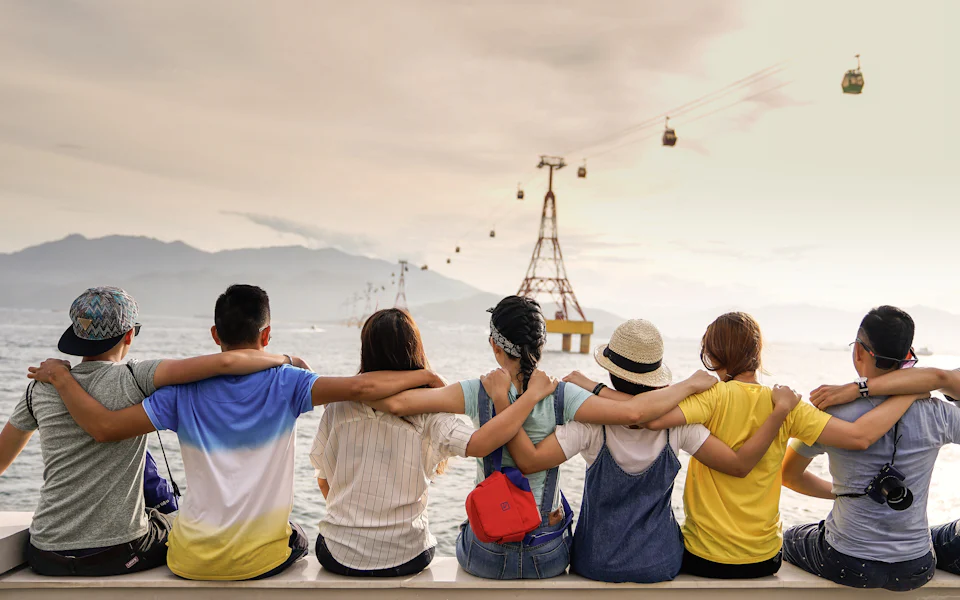 Barkada of friends sitting arm in arm enjoying the view together